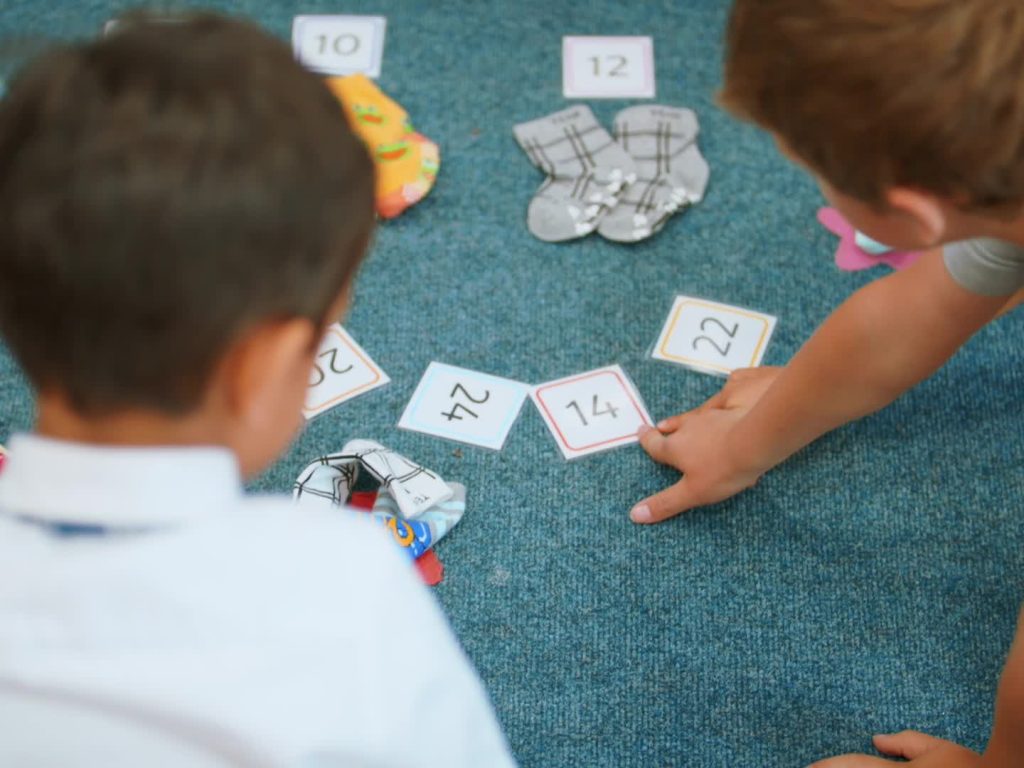 child pointing to a number card
