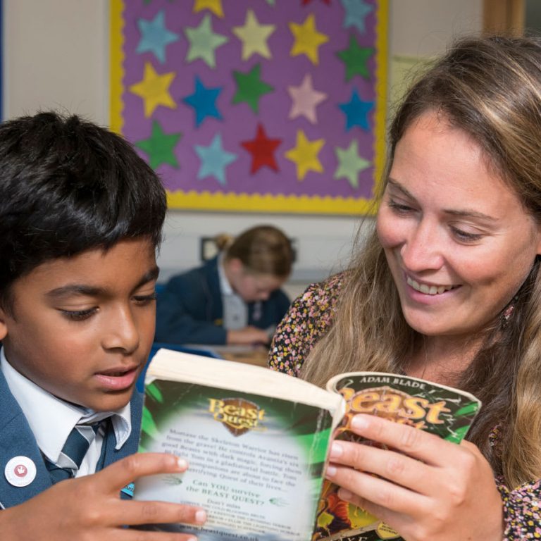 child reading to teacher