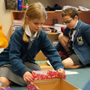 child wrapping a box