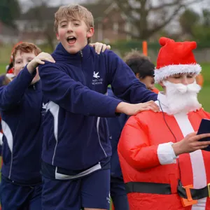 students behind a person dressed like santa