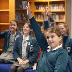 students with their hands in the air