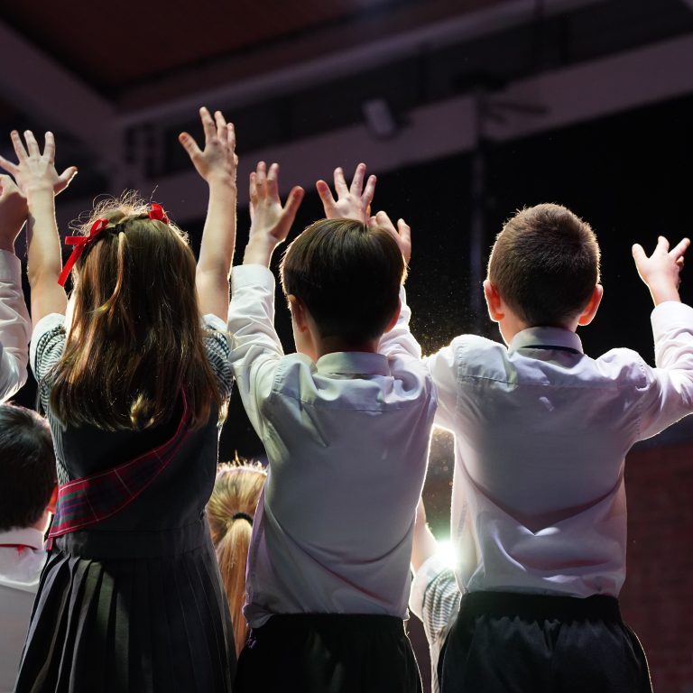 students with their hands up