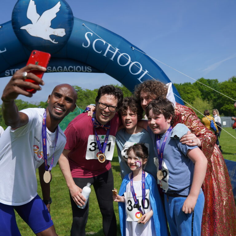Mo Farah taking a selfie with students and teachers