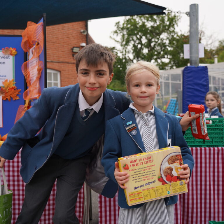 2 students holding up some food