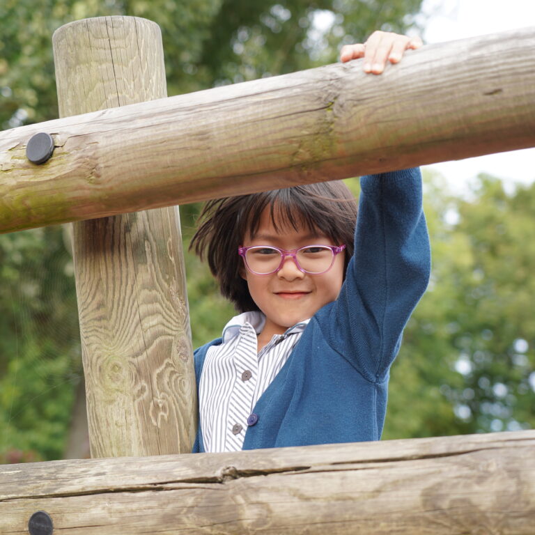 girl on a wooden climbing frame