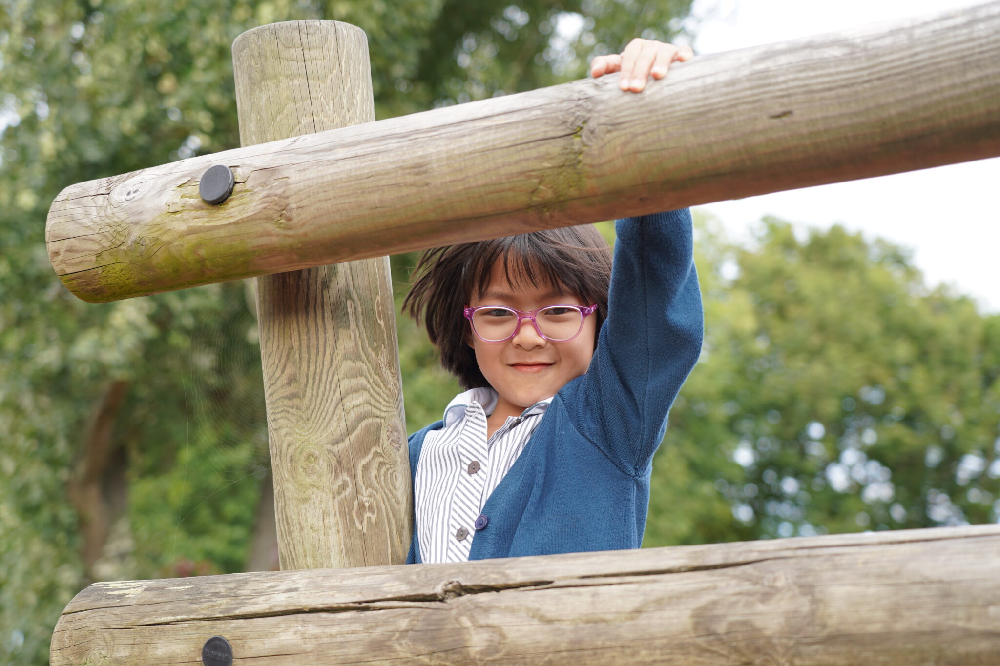 girl on a wooden climbing frame