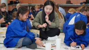 students painting on the floor