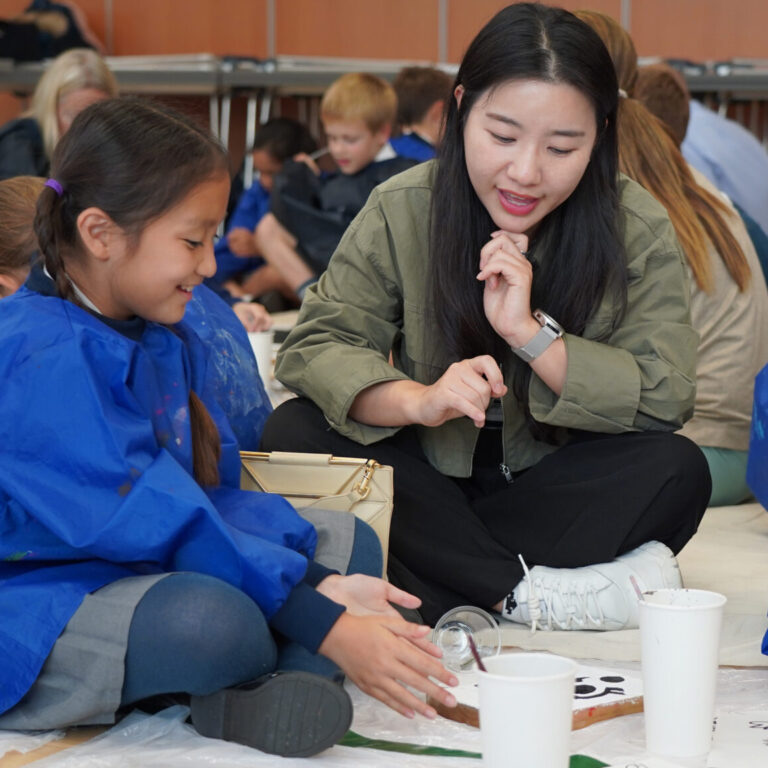 students painting on the floor