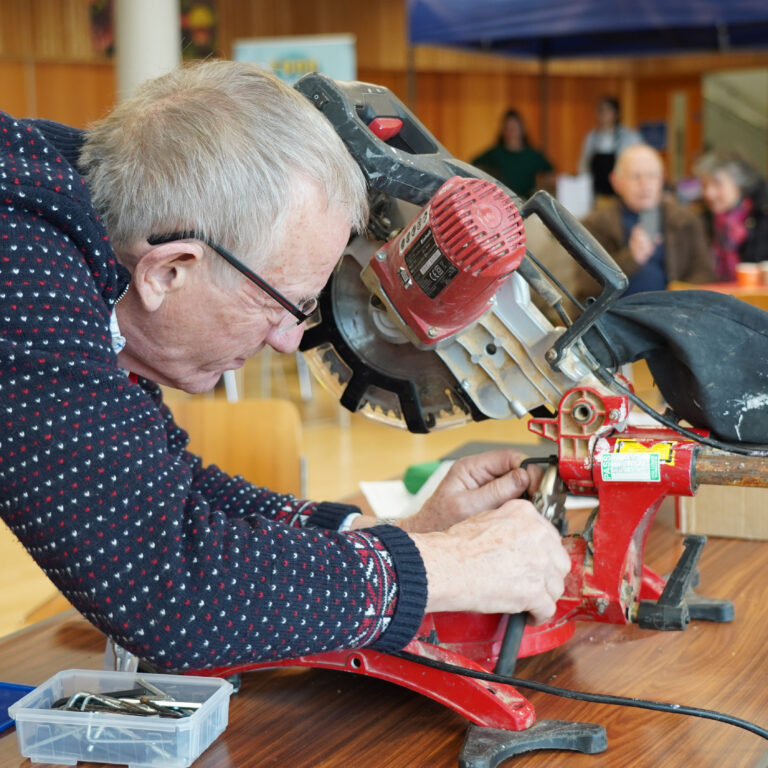 voluneer fixing a machine