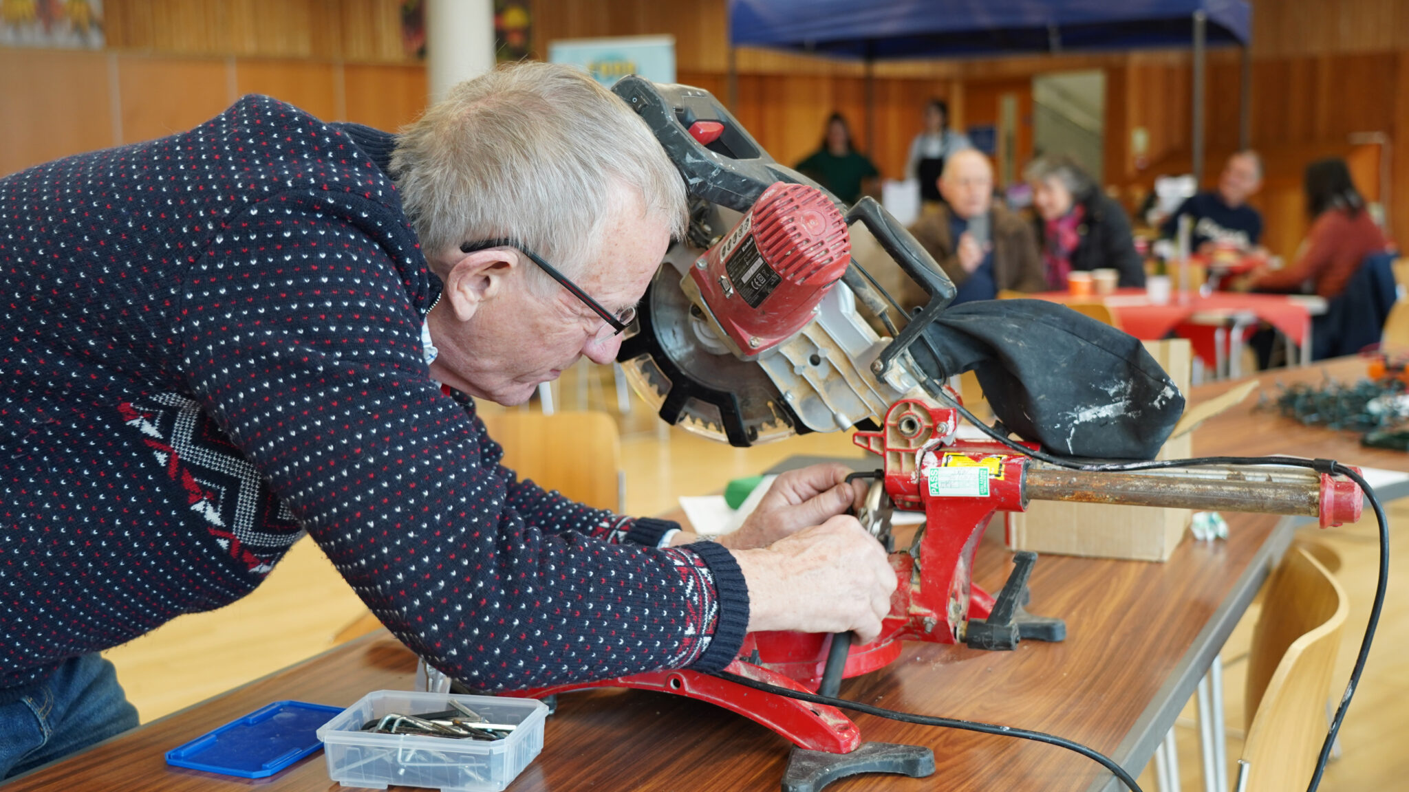 voluneer fixing a machine